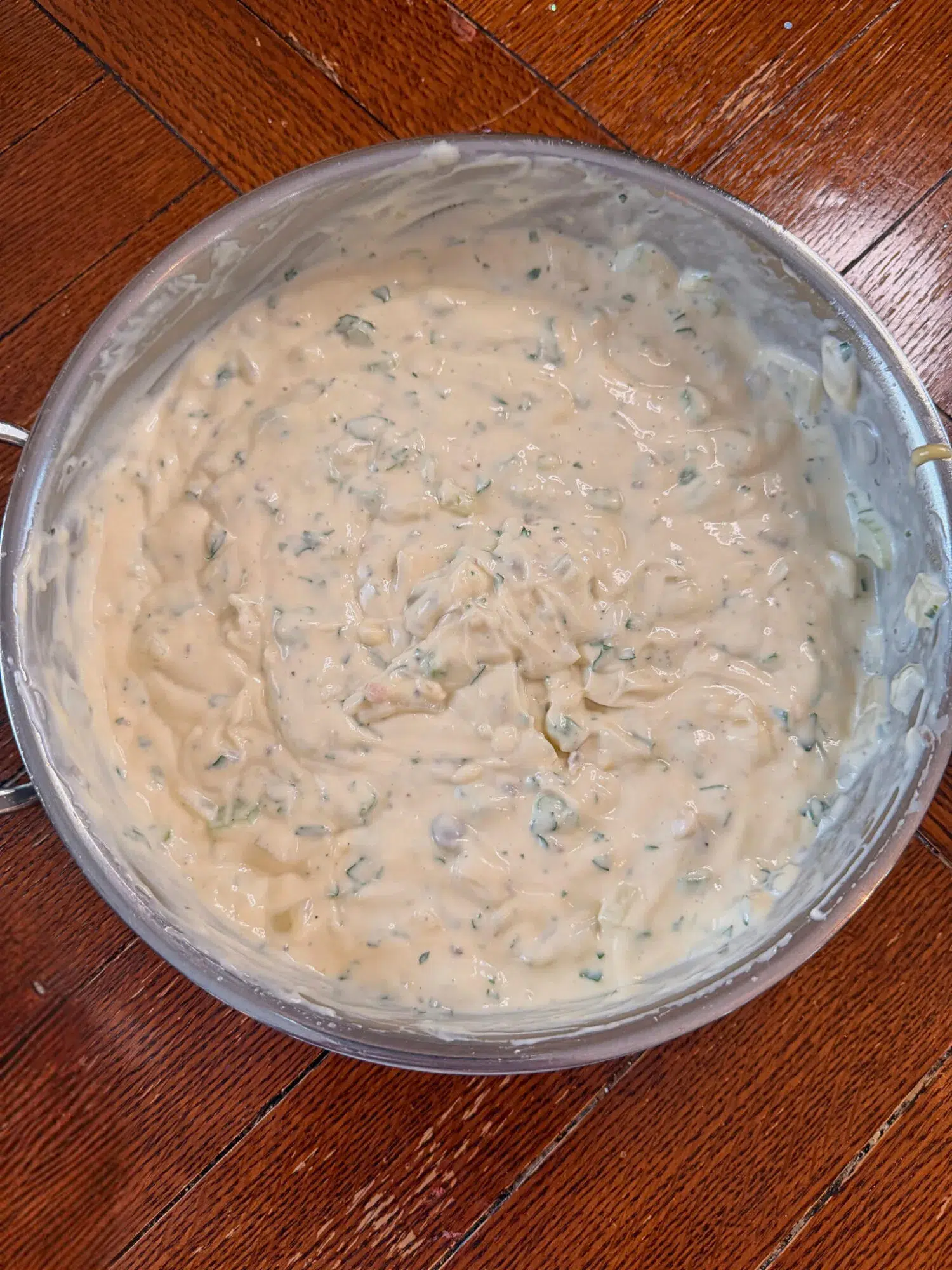 Creamy veggie sauce for chicken wild rice bake in a pan.