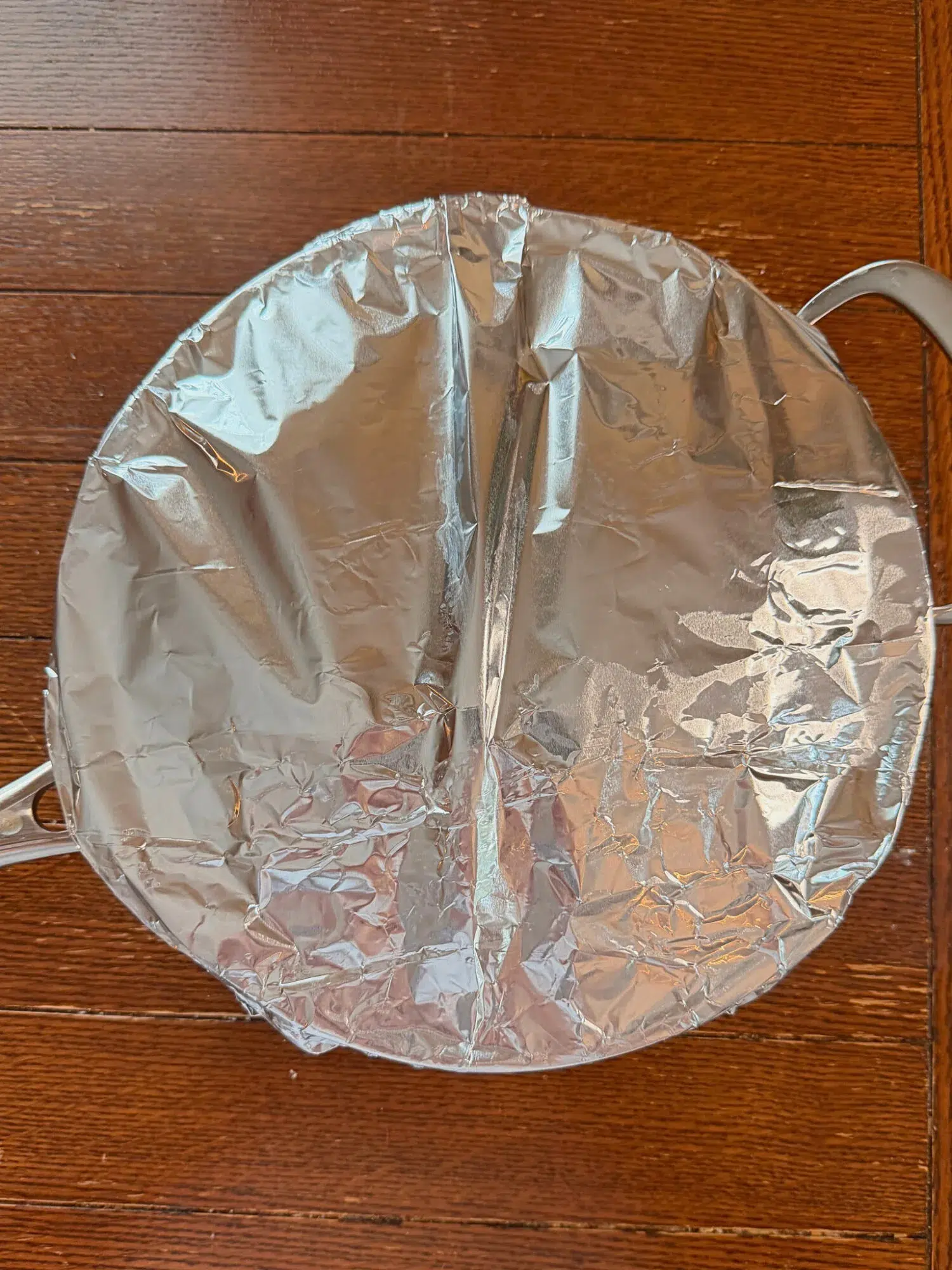 Tin foil sealed over a baking pan ready to go in the oven.