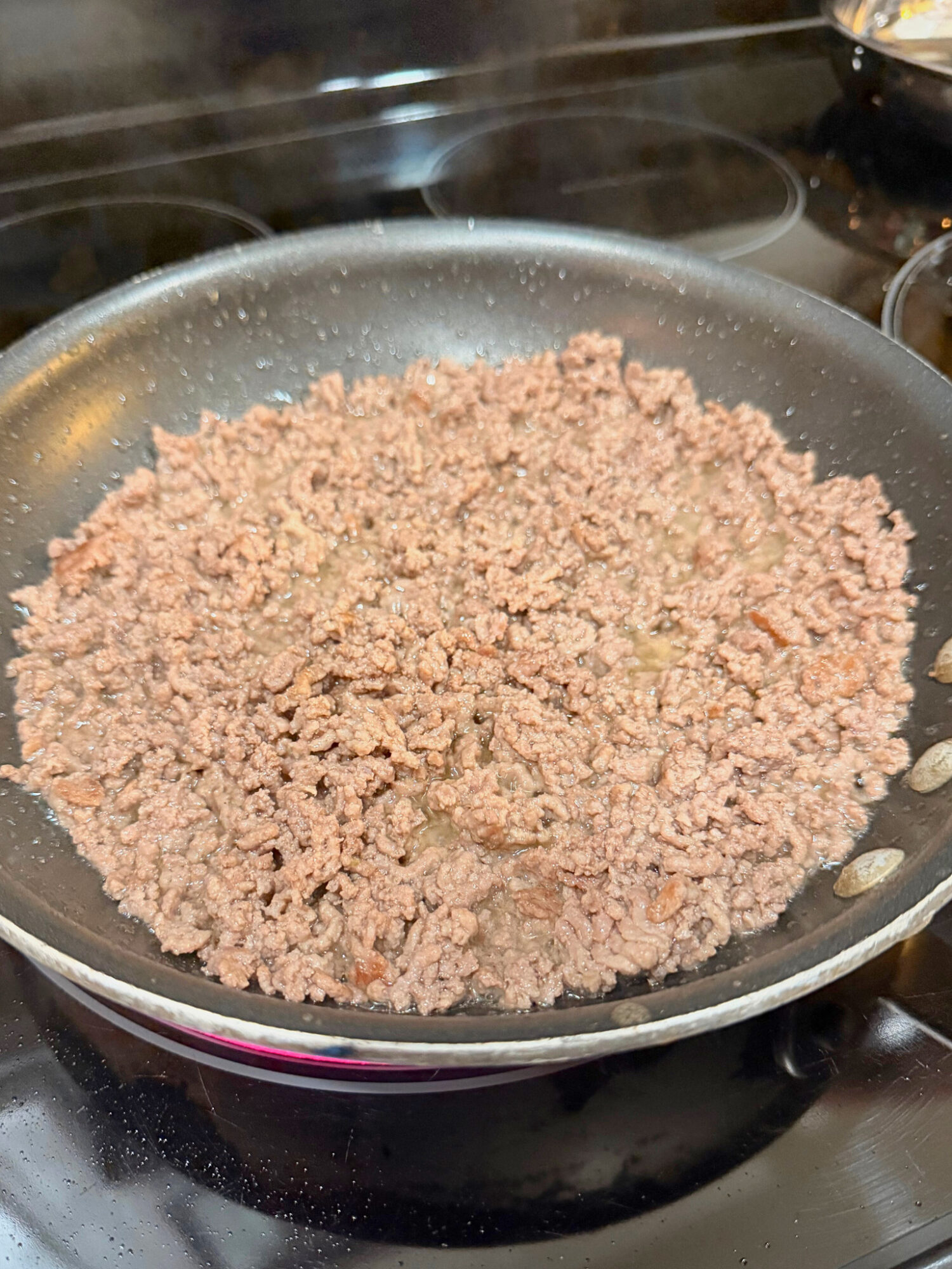 Browned beef in a skillet.