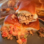 Stacked ground beef queso sliders on a plate.