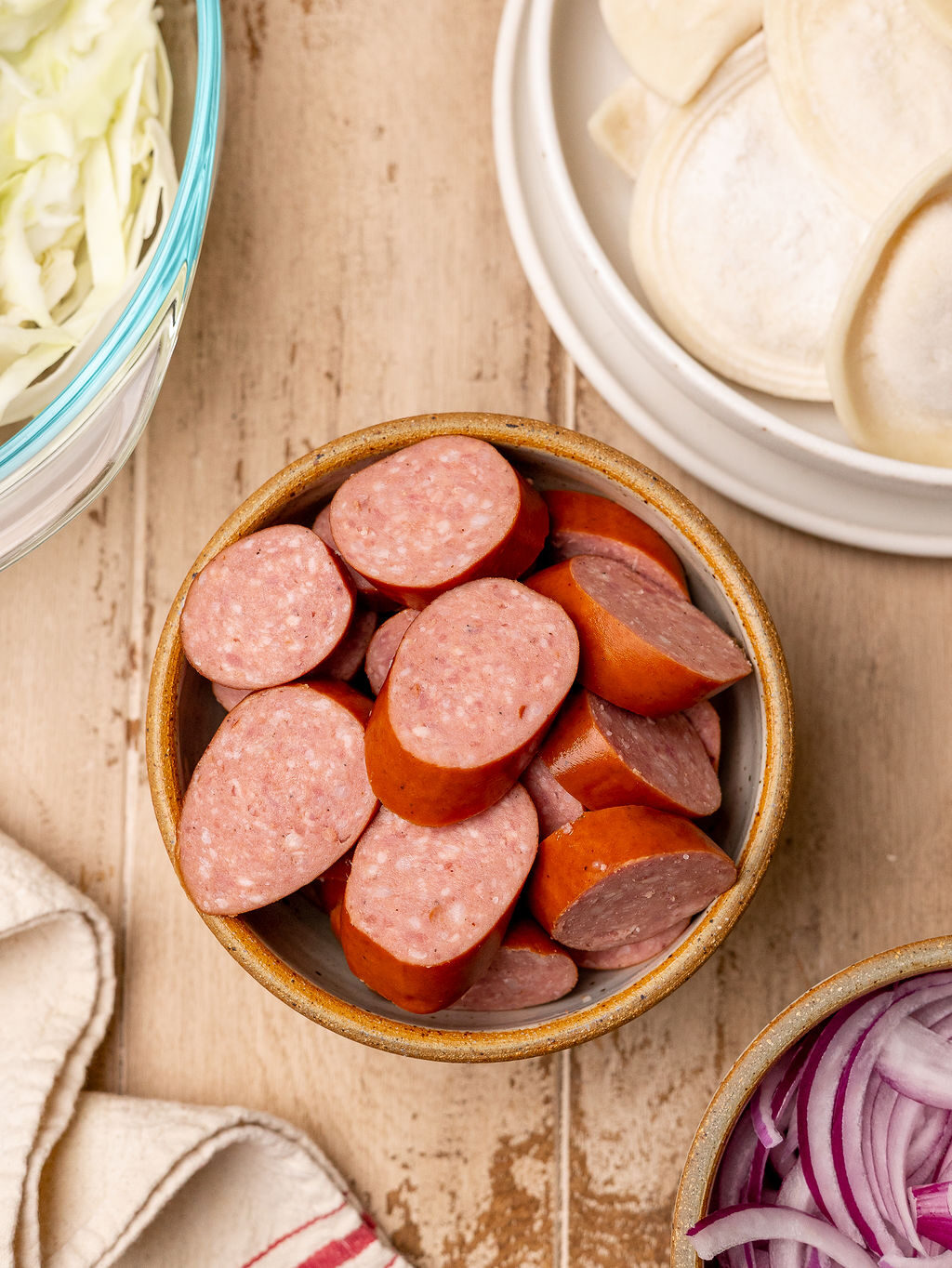 Sliced kielbasa in a bowl.