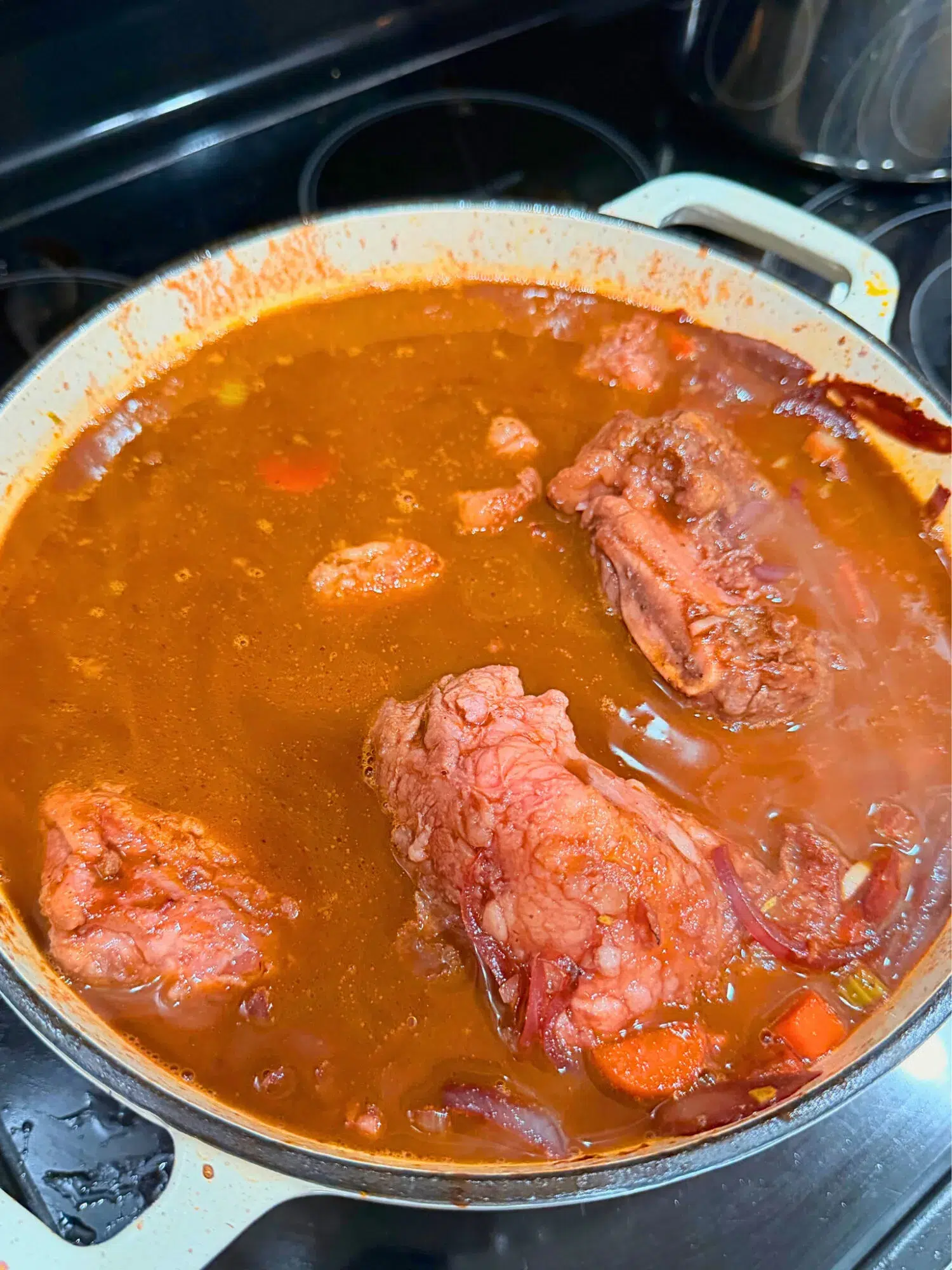 Braising short ribs in a Dutch oven.