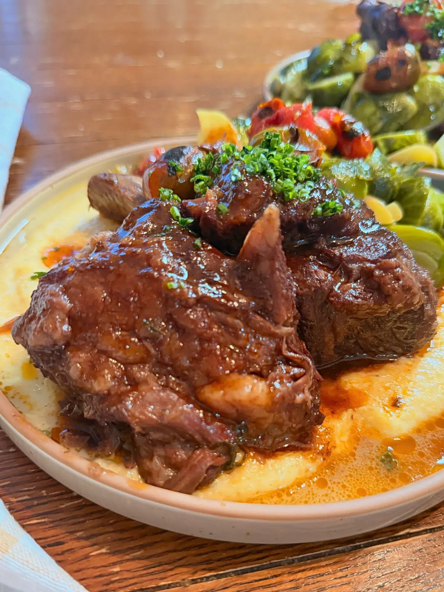 Short ribs over a bowl of polenta.