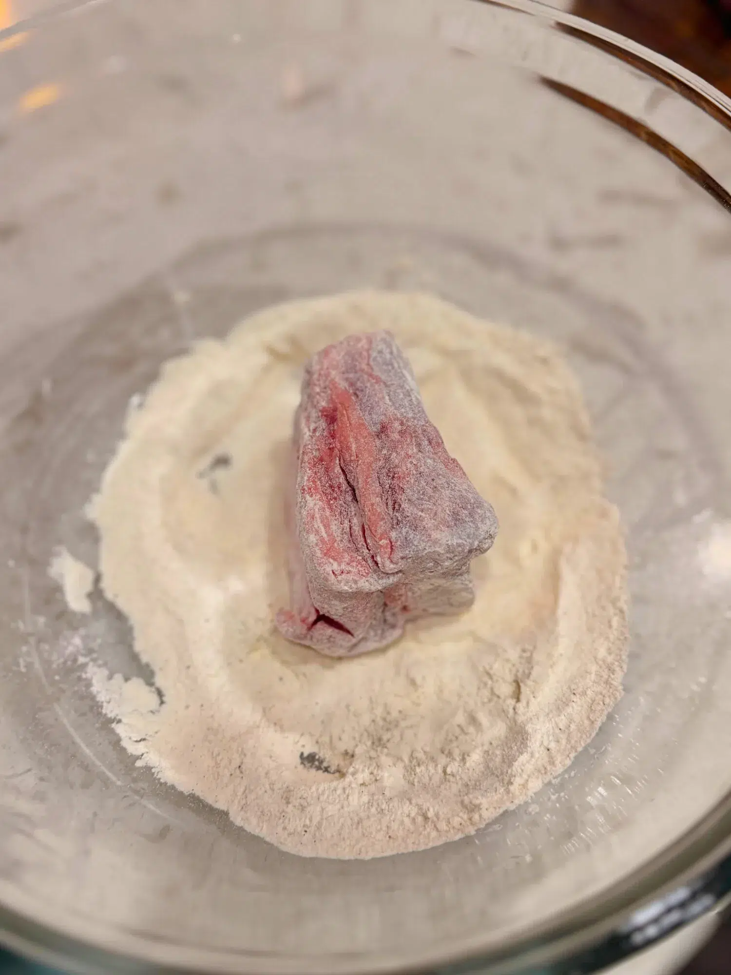 Coating short ribs in flour.