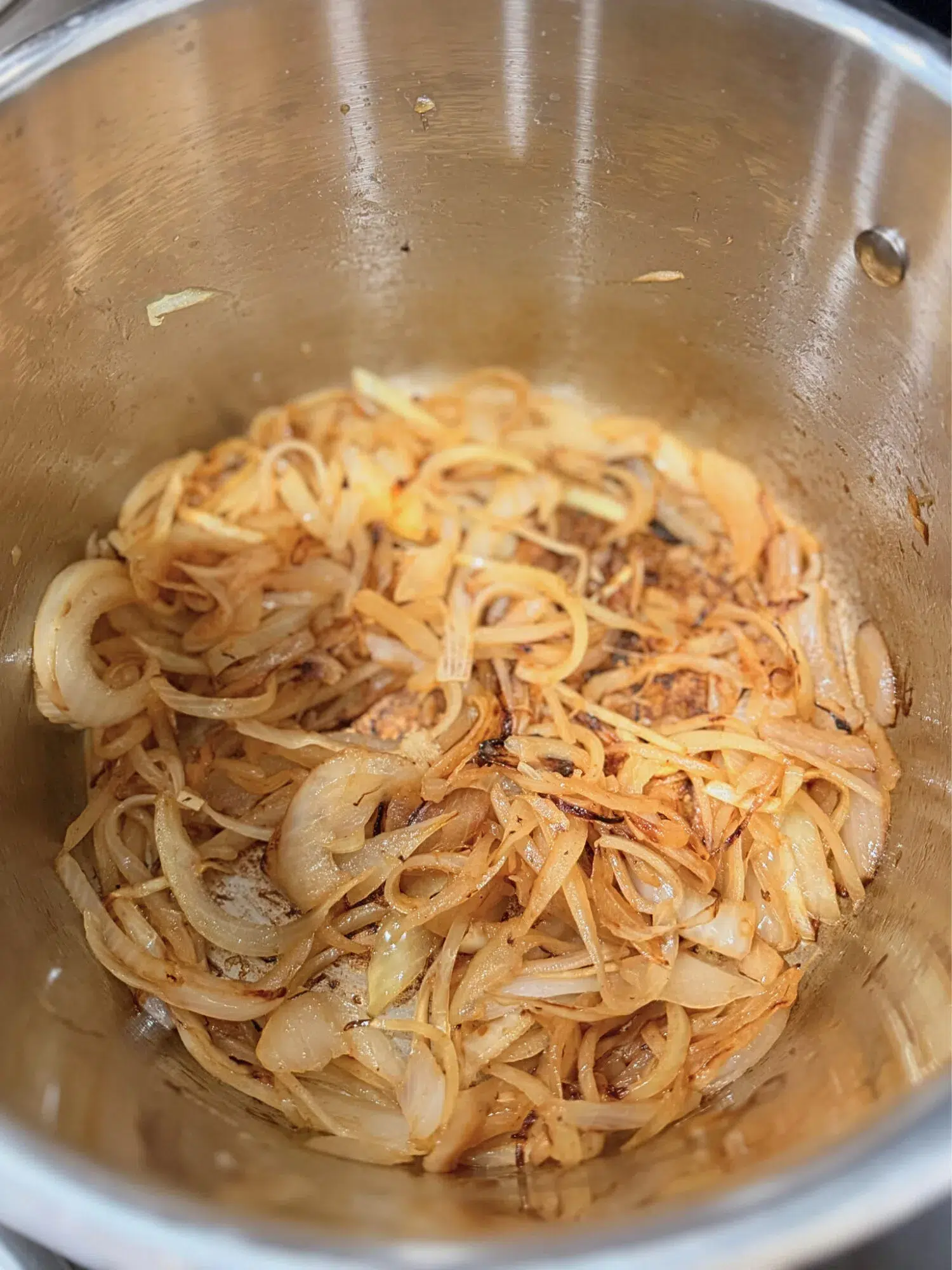 Cooked onions in a pot.