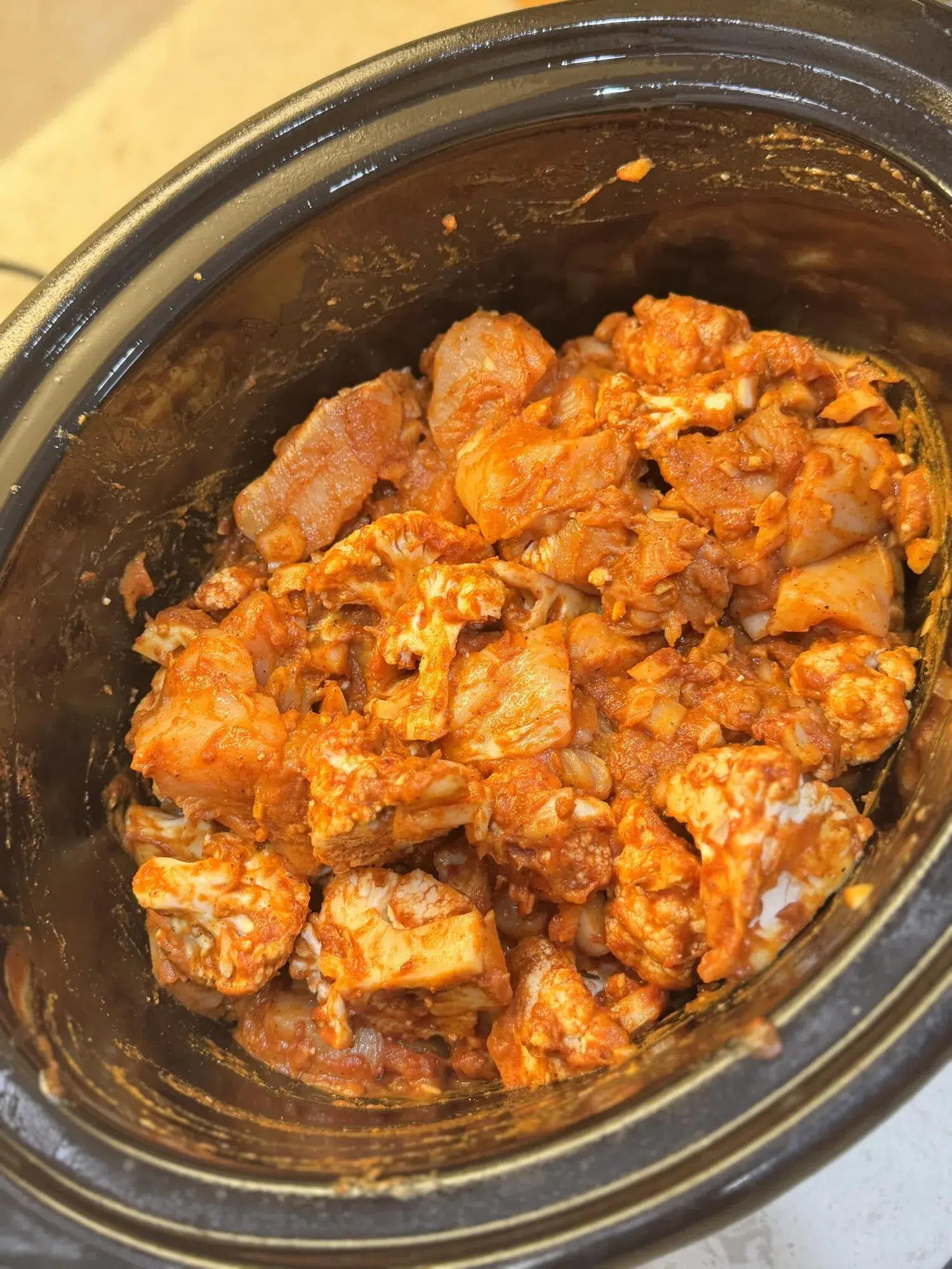 Seasoned chicken in a slow cooker ready to cook.
