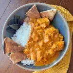 A serving of slow cooker butter chicken with naan.