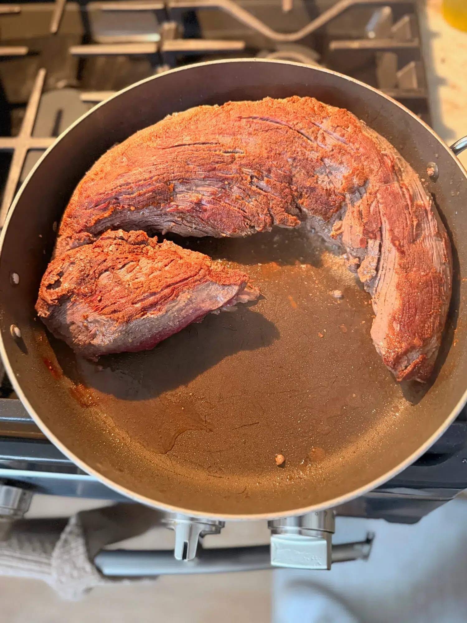 Searing beef tenderloin on a skillet.