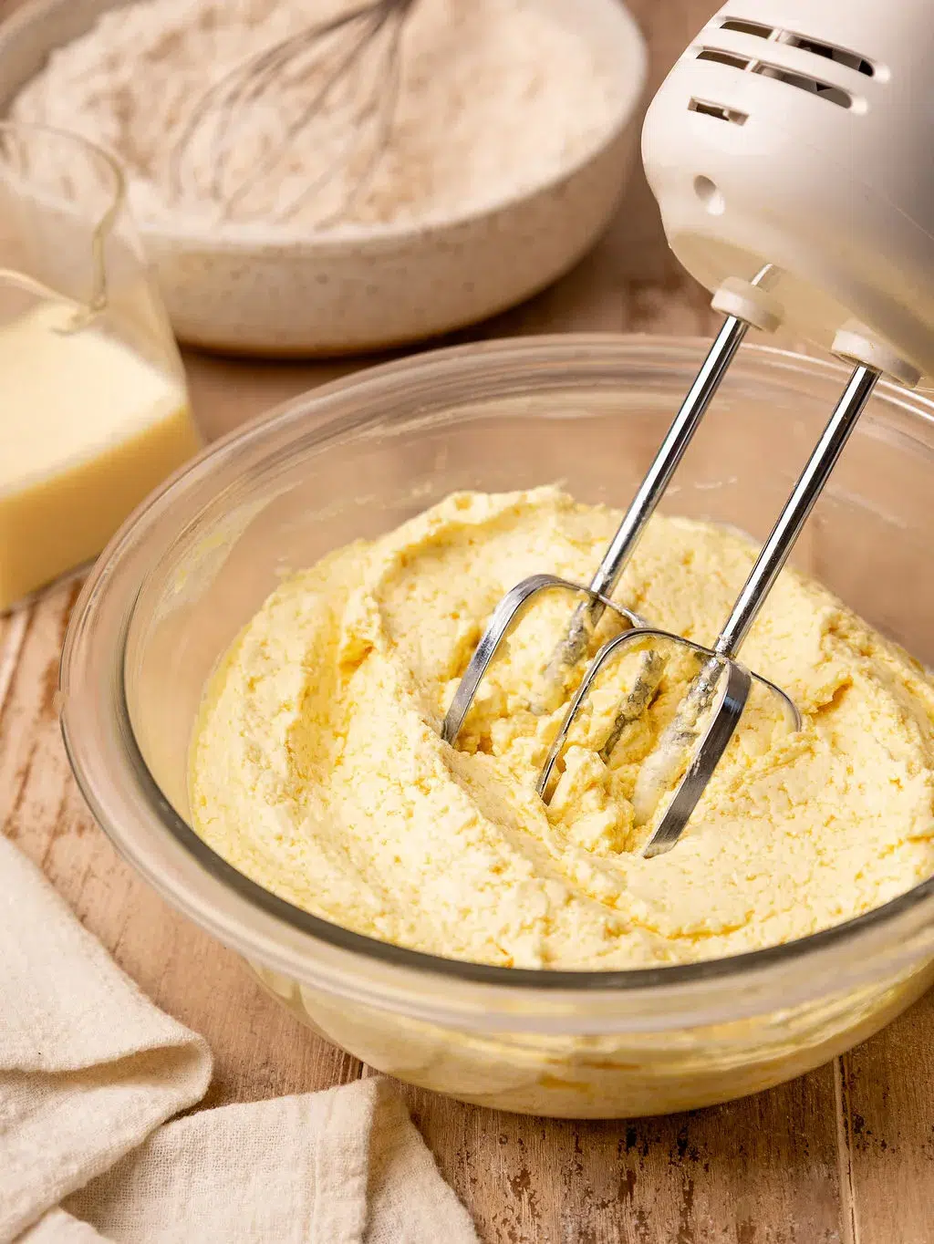 An electric mixer creaming the butter and sugar.