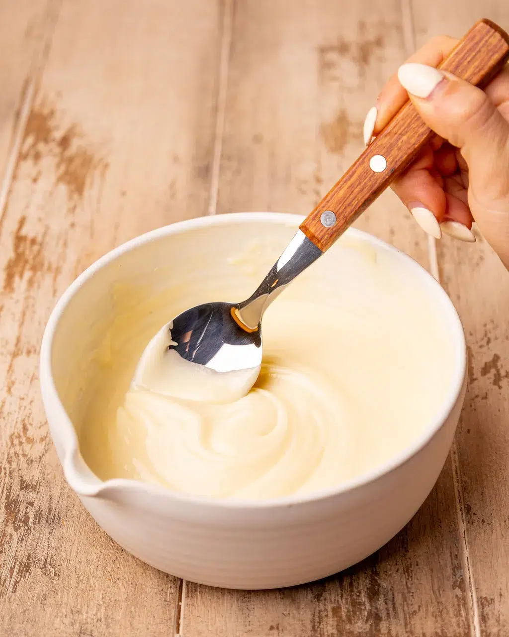 Mixing the eggnog icing for eggnog bread.