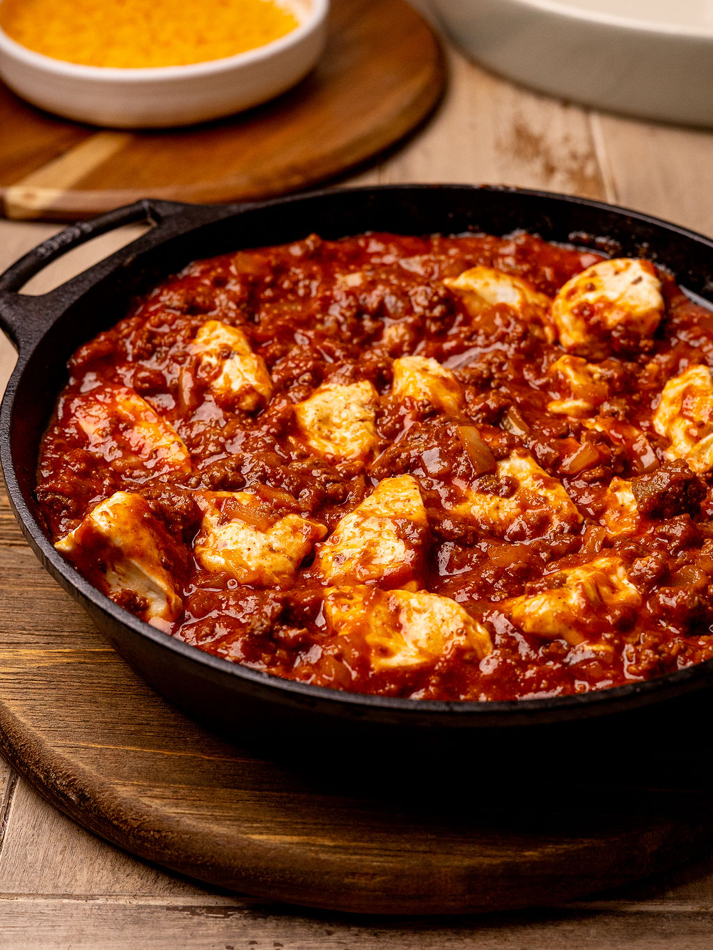 Filling for sloppy joe biscuit bake in a cast iron skillet.