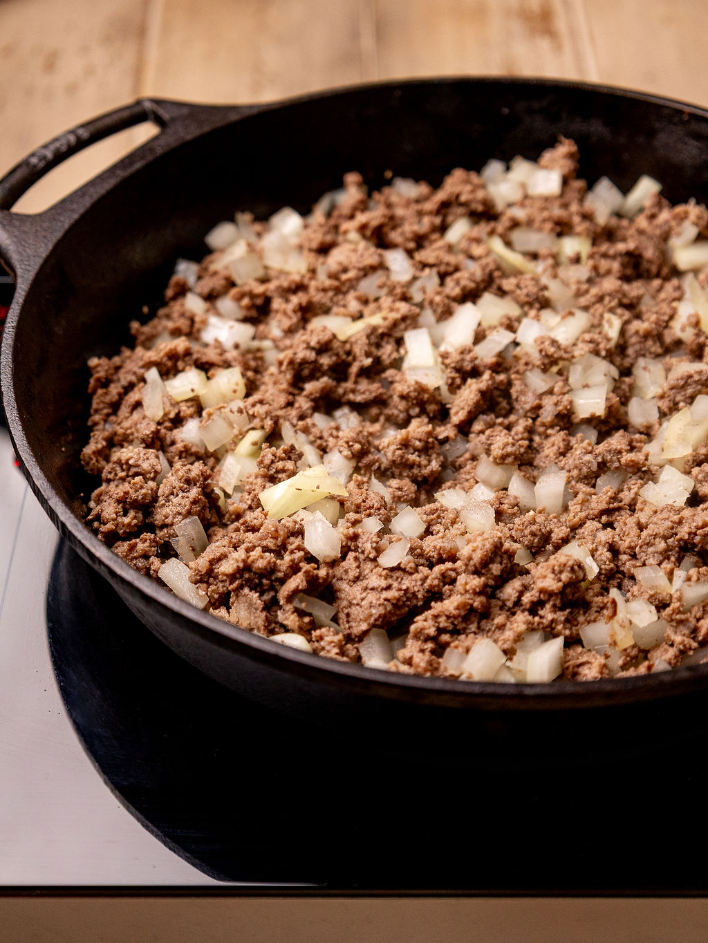 Browned beef and onions in a cast iron skillet.