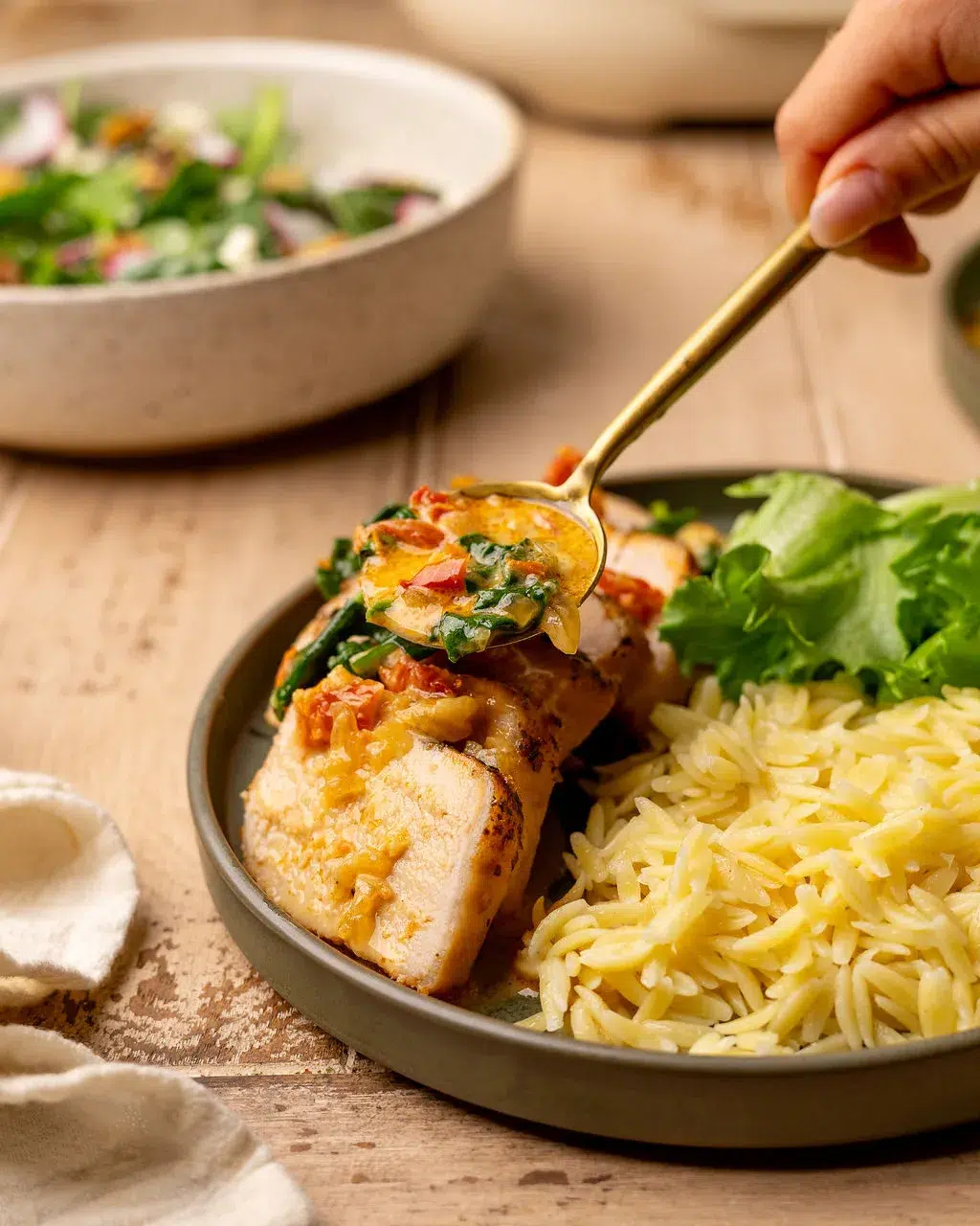 Adding Tuscan sauce to sliced slow cooked pork tenderloin.