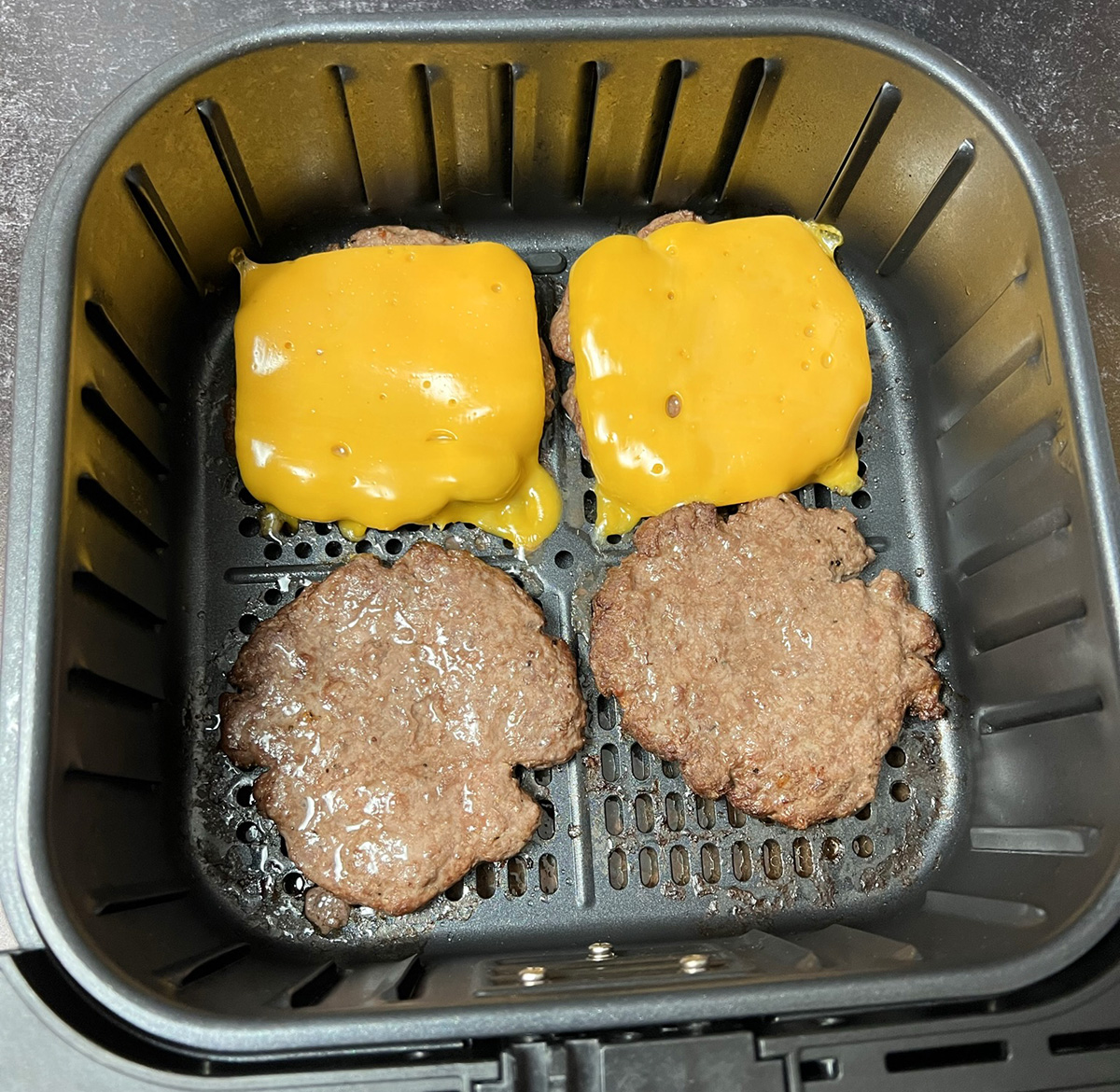 Burgers cooking in an air fryer