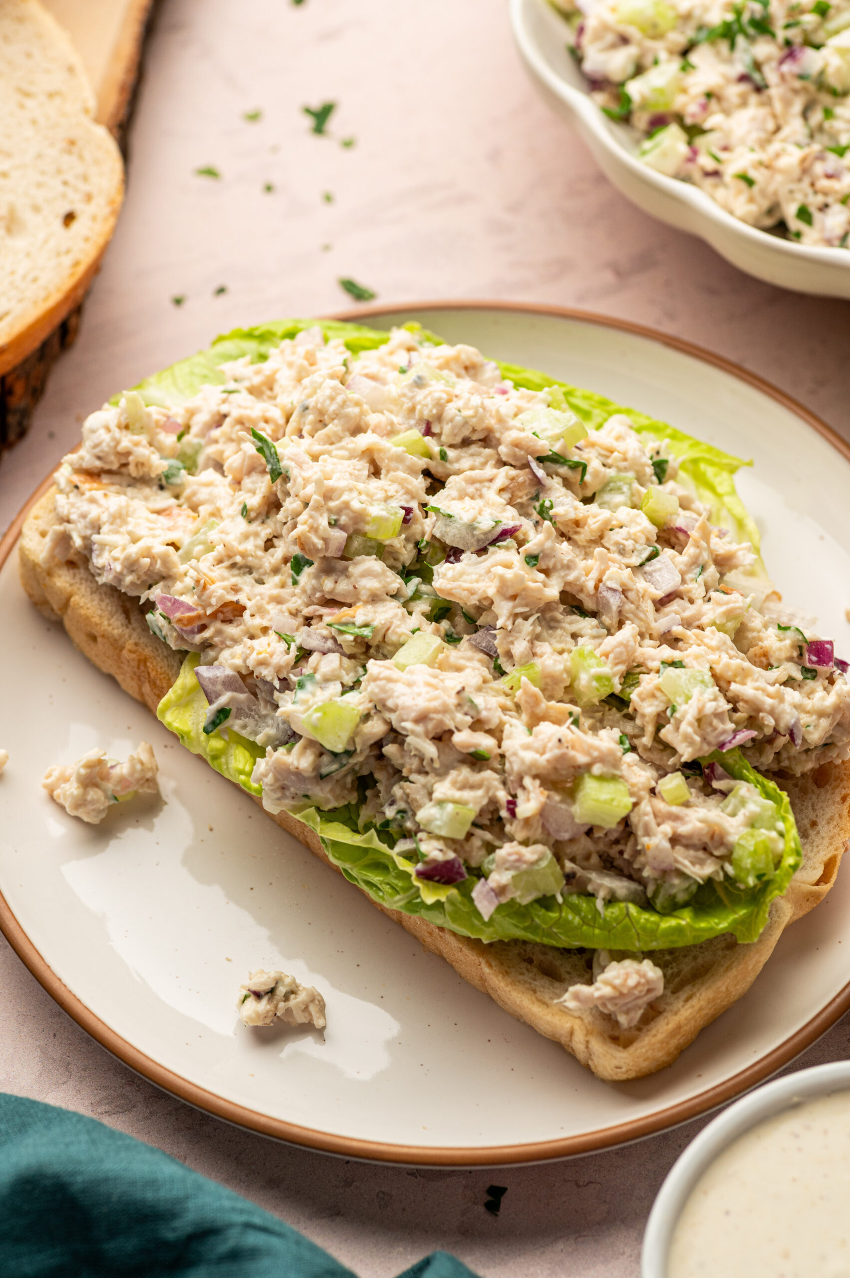 Healthy Caesar Chicken salad over lettuce and toast.