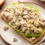 Healthy Caesar Chicken salad over lettuce and toast.