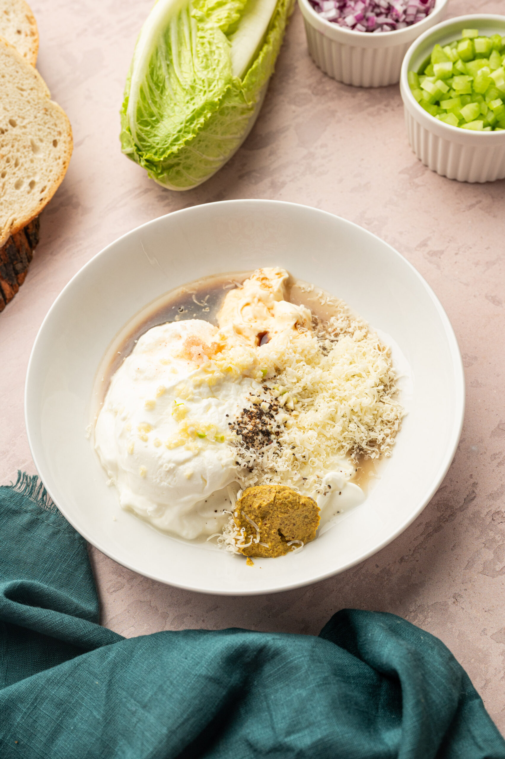 Mixing the dressing for Caesar chicken salad.