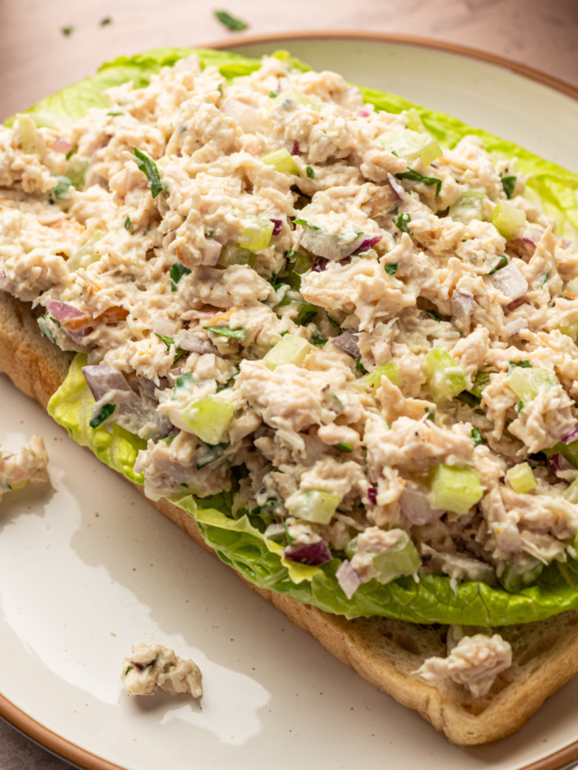 Healthy Caesar Chicken salad over lettuce and toast.