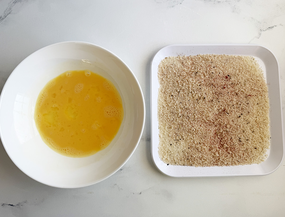 A simple breading setup of just egg and panko breadcrumbs to make the Best Damn Breaded Air Fryer Pork Chops. No flour needed.