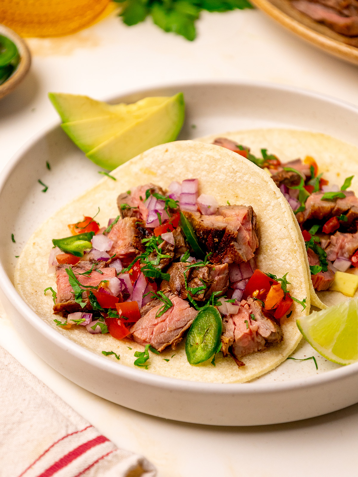 Carne asada steak served on tortillas with all the fixins.